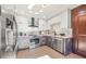 Modern kitchen features stainless steel appliances, two tone cabinets, and a breakfast area at 3228 7Th N Ave, St Petersburg, FL 33713