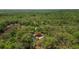 Serene aerial shot showcases the property surrounded by lush, mature trees and natural landscape creating a private oasis at 34193 Carpenter Cir, Webster, FL 33597
