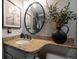 Bathroom vanity featuring granite countertop and black accent pieces at 3500 Gulf Blvd # 314, Belleair Beach, FL 33786