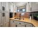 Close-up of sink in modern kitchen featuring granite countertops and updated cabinetry at 3500 Gulf Blvd # 314, Belleair Beach, FL 33786