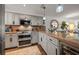Well-equipped kitchen with stainless steel appliances, granite countertops, and stylish gray cabinetry at 3500 Gulf Blvd # 314, Belleair Beach, FL 33786