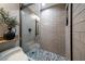 A tiled shower with a glass door and a decorative plant at 3500 Gulf Blvd # 314, Belleair Beach, FL 33786