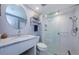 Modern bathroom featuring a glass-enclosed shower, marble countertop and round mirror at 36750 Us 19 N # 5-111, Palm Harbor, FL 34684
