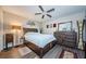 Comfortable bedroom with wood-look floors, ceiling fan, and dresser set at 36750 Us 19 N # 5-111, Palm Harbor, FL 34684