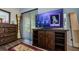 Bedroom features wood-look floors, sliding glass door, TV, and chest of drawers at 36750 Us 19 N # 5-111, Palm Harbor, FL 34684