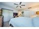 View of bedroom with fan, closet, TV, dresser, and wood-look floors at 36750 Us 19 N # 5-111, Palm Harbor, FL 34684