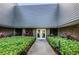 Inviting building entrance with manicured landscaping, providing a welcoming atmosphere at 36750 Us 19 N # 5-111, Palm Harbor, FL 34684