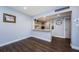 Cozy dining area showing wood floors, a granite breakfast bar, and decoratively tiled kitchen beyond at 36750 Us 19 N # 5-111, Palm Harbor, FL 34684