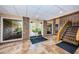 View of the bright entryway with brick columns and a tiled floor at 36750 Us 19 N # 5-111, Palm Harbor, FL 34684
