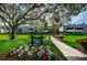 Inviting condo community with lush landscaping and a charming sign at 36750 Us 19 N # 5-111, Palm Harbor, FL 34684