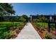 Exterior of building featuring a well-manicured lawn with beautiful plants and flowers on a bright sunny day at 36750 Us 19 N # 5-111, Palm Harbor, FL 34684