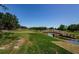 Scenic view of golf course with stone bridge over stream, trees, and blue sky at 36750 Us 19 N # 5-111, Palm Harbor, FL 34684