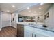 Open kitchen featuring granite countertops and stainless steel appliances overlooking the living room at 36750 Us 19 N # 5-111, Palm Harbor, FL 34684