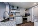 Modern kitchen showcasing stainless appliances, granite counters, light cabinetry, and stylish backsplash at 36750 Us 19 N # 5-111, Palm Harbor, FL 34684