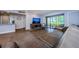 Living room space with wood floors and a large sliding glass door to the exterior at 36750 Us 19 N # 5-111, Palm Harbor, FL 34684