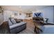 Comfortable living room with wood floors, gray sofa, entertainment center, and neutral color scheme at 36750 Us 19 N # 5-111, Palm Harbor, FL 34684