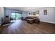 Spacious living room featuring wood floors, a leather sofa, and sliding doors to the patio at 36750 Us 19 N # 5-111, Palm Harbor, FL 34684