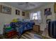 Cozy bedroom with whimsical decor, a comfortable bed, and natural light streaming through the window at 3721 140Th Ave, Largo, FL 33771