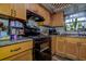 Traditional kitchen with wood cabinets, granite countertops, and modern appliances at 3721 140Th Ave, Largo, FL 33771