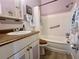 Cozy bathroom featuring a shower-tub combo with safety bar, plus charming vanity and wooden accents at 4001 58Th N St # 18, Kenneth City, FL 33709