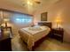 Cozy bedroom featuring a bed with a patterned quilt, side tables, and natural light at 4001 58Th N St # 18, Kenneth City, FL 33709
