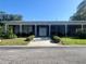 Exterior of community building with well-manicured lawn and covered entrance at 4001 58Th N St # 18, Kenneth City, FL 33709
