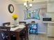 Cozy dining room boasts a modern chandelier and a view into the kitchen at 4001 58Th N St # 18, Kenneth City, FL 33709