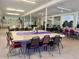 Large community dining area with tables and chairs set for a gathering at 4001 58Th N St # 18, Kenneth City, FL 33709