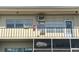 A closer view of the condo's second-story exterior showing multiple windows and a balcony at 4001 58Th N St # 18, Kenneth City, FL 33709