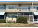 Two-story condo building featuring multiple units and exterior screened in patio at 4001 58Th N St # 18, Kenneth City, FL 33709