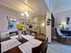 Charming kitchen with bright white cabinetry, modern appliances, and adjacent dining area with flower centerpiece at 4001 58Th N St # 18, Kenneth City, FL 33709