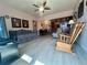 The living room features ample seating, wood flooring, and abundant natural light at 4001 58Th N St # 18, Kenneth City, FL 33709