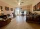 Bright living room featuring abundant seating, an entry door, and updated flooring at 4001 58Th N St # 18, Kenneth City, FL 33709