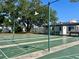 Community shuffleboard court lined with shade trees and seating area at 4001 58Th N St # 18, Kenneth City, FL 33709