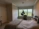 Cozy bedroom with lots of natural light, wood-look floors, neutral walls, and stylish decor at 4053 Rocky Shores Dr, Tampa, FL 33634