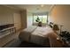 Spacious bedroom with natural light from the window, wood-look flooring, and a comfortable, uncluttered design at 4053 Rocky Shores Dr, Tampa, FL 33634
