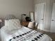 Inviting bedroom with a comfortable bed, a cozy desk, and warm natural light filtering in through the windows at 4053 Rocky Shores Dr, Tampa, FL 33634