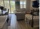 The living room with large windows offers great natural light, beautiful floors, and comfortable seating at 4053 Rocky Shores Dr, Tampa, FL 33634