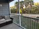Relaxing screened patio with comfortable seating and a view of lush greenery and palm trees at 4053 Rocky Shores Dr, Tampa, FL 33634