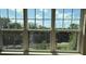 Bright window view overlooking a golf course and green space with scenic views of palm trees and blue skies at 4053 Rocky Shores Dr, Tampa, FL 33634