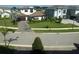 Screened window view overlooking perfectly manicured front yard landscapes and beautiful homes in a quiet neighborhood at 4053 Rocky Shores Dr, Tampa, FL 33634