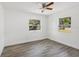 Bright bedroom with ceiling fan and hardwood floors, featuring two windows at 419 40Th S Ave, St Petersburg, FL 33705