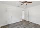 Clean bedroom space with laminate flooring, two doors, a ceiling fan, and crisp white walls at 419 40Th S Ave, St Petersburg, FL 33705