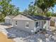 Charming house in gray with blue shutters and a detached garage at 419 40Th S Ave, St Petersburg, FL 33705