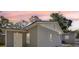 Gray exterior of the house with a detached garage under a beautiful sunset at 419 40Th S Ave, St Petersburg, FL 33705