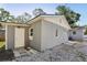 Detached garage with a white door, gray exterior, and gravel landscaping at 419 40Th S Ave, St Petersburg, FL 33705