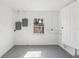 Empty room with painted floor, one window, electrical box, and white door at 419 40Th S Ave, St Petersburg, FL 33705