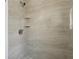 Modern shower featuring light tan tile, shower head, and two corner shelves at 419 40Th S Ave, St Petersburg, FL 33705
