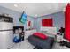 Cozy bedroom with a TV, a compact kitchen setup, and a stylish modern design at 4416 W Minnehaha St, Tampa, FL 33614