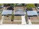 Aerial view of the home showcasing the roof, driveway, and surrounding landscaping at 4732 W Wyoming Ave, Tampa, FL 33616